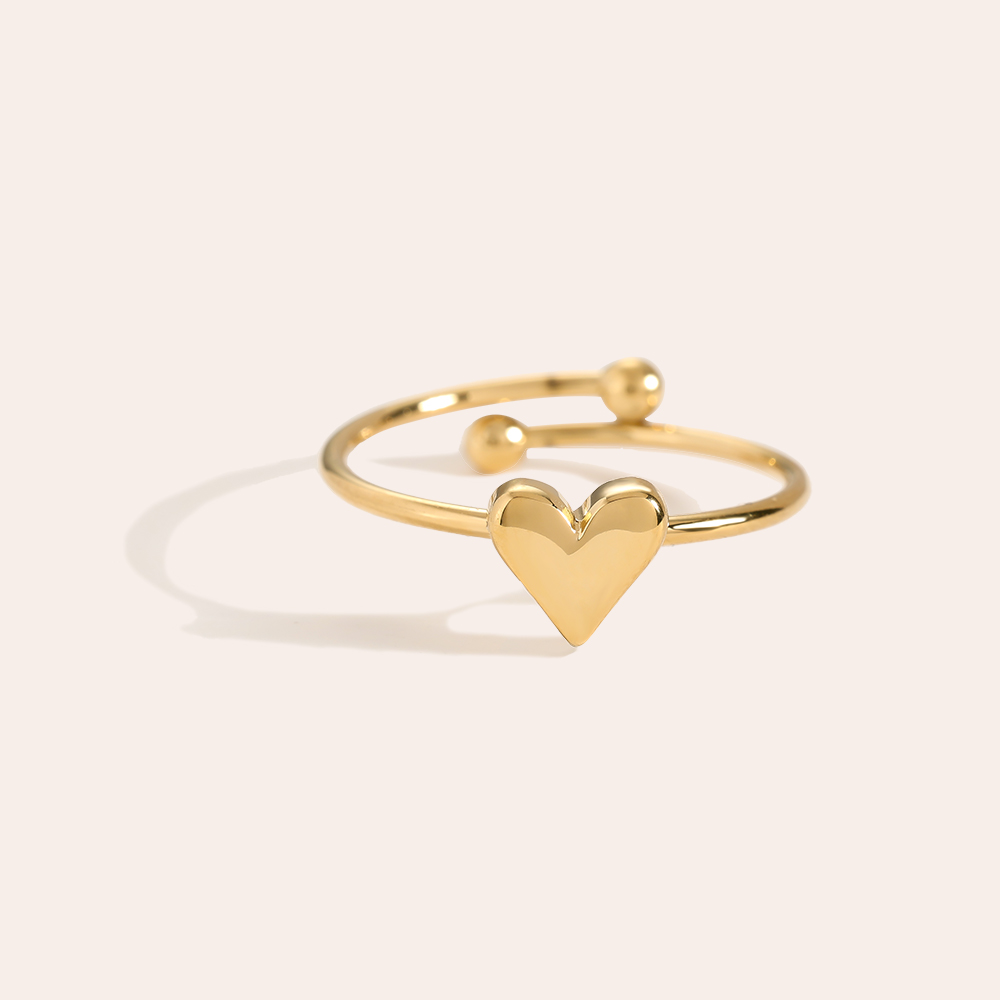 Goldfarbener Edelstahlring mit Herzmotiv und offenem Design, zwei Kugelenden