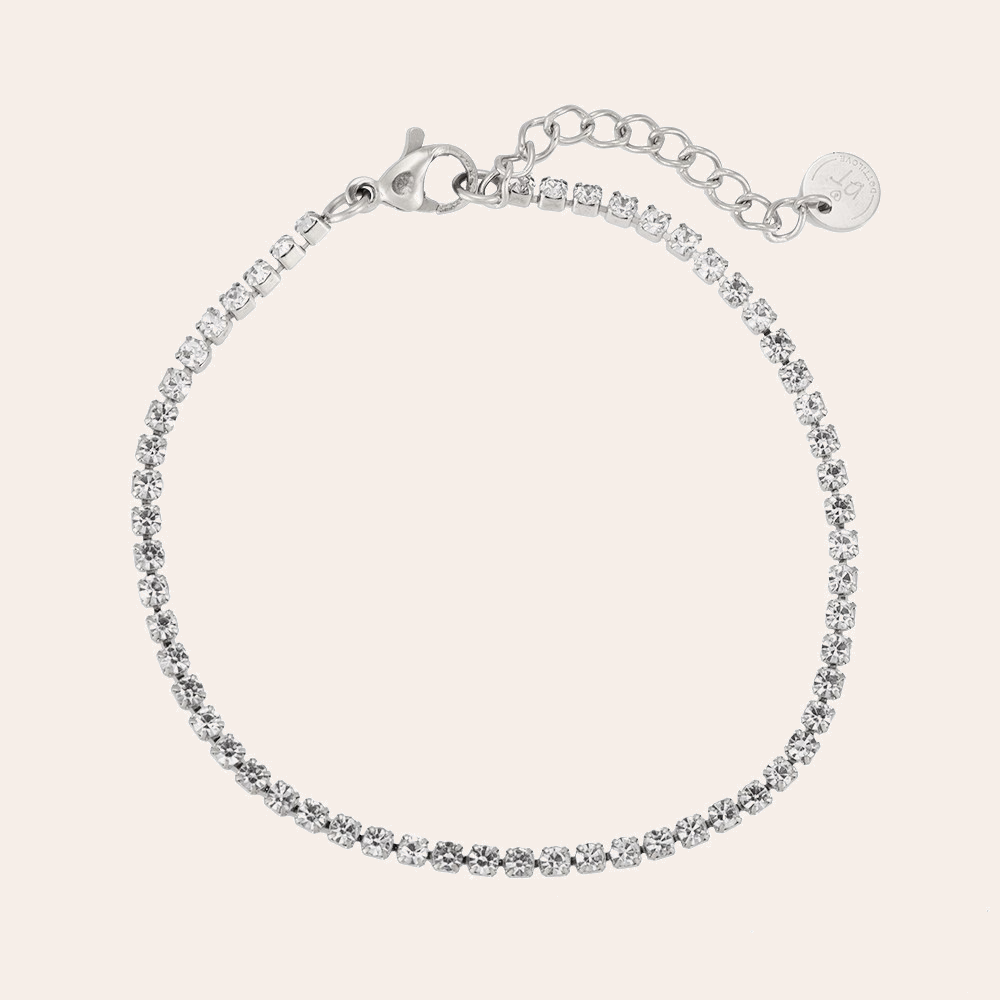 Silbernes Tennisarmband aus Edelstahl mit funkelnden Steinen und verstellbarem Verschluss.