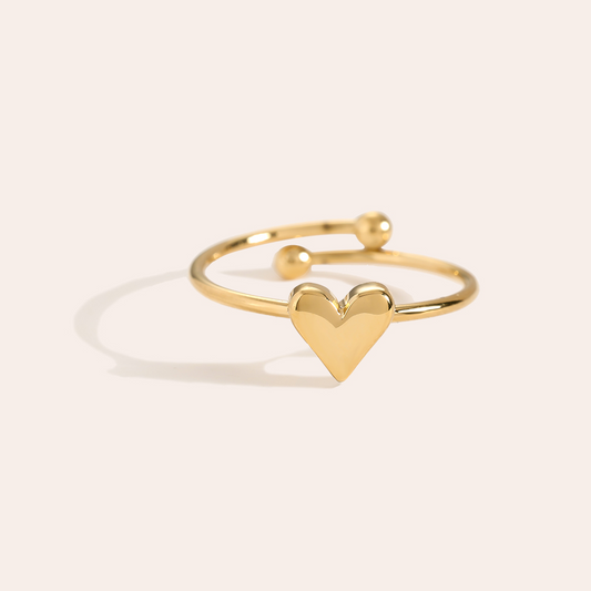 Goldfarbener Edelstahlring mit Herzmotiv und offenem Design, zwei Kugelenden